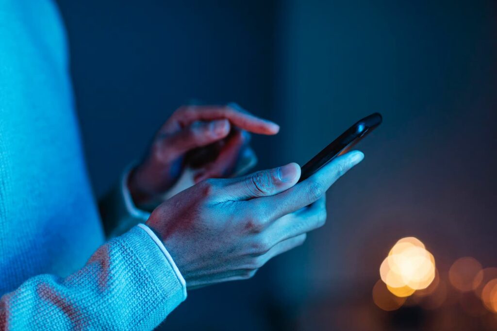 Side view of man using smartphone